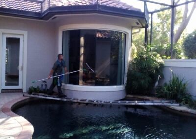 Skilled Professional Expertly Cleaning Curved Glass Window