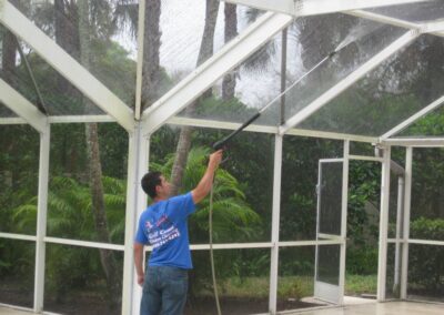 A man holding a window cleaning tool in his hand.