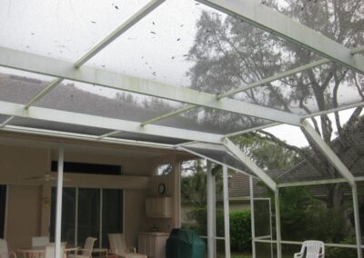A patio with a table and chairs in the middle of it.