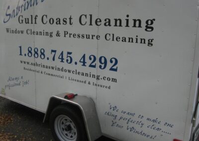 A white trailer with the words gulf coast cleaning written on it.
