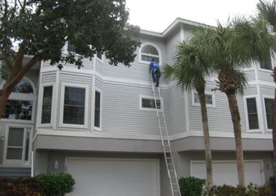 A ladder is being used to reach the top of a house.