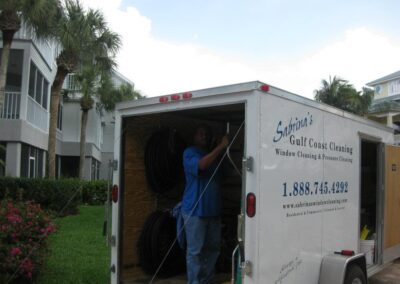 A man standing in the back of a moving truck.