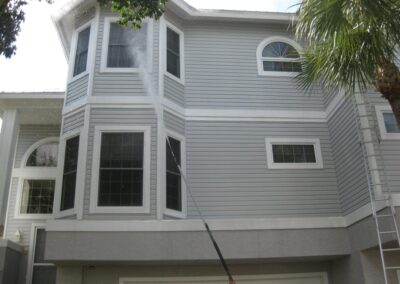 A house with a window cleaning service in progress.
